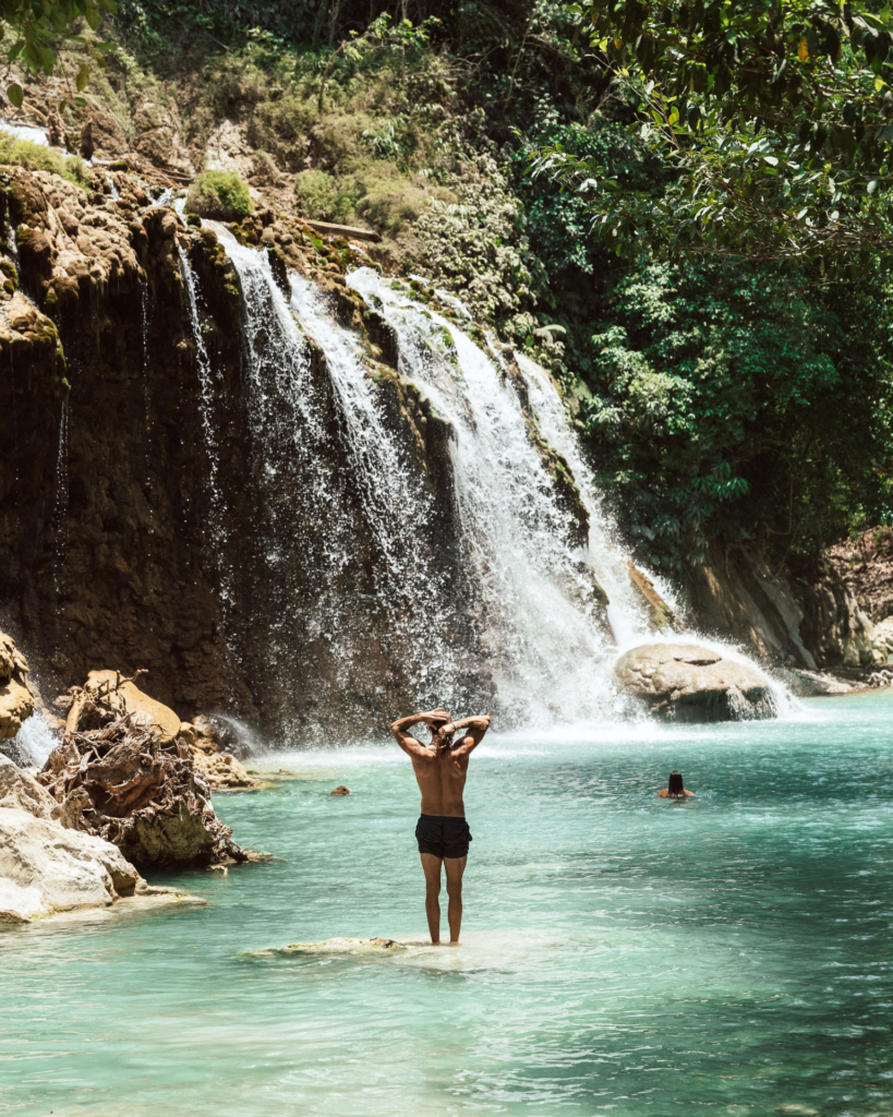 Nomad enjoying hidden waterfall on Sumba Island indonesia